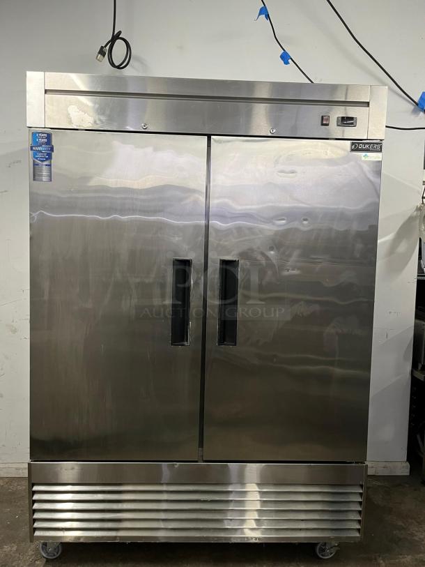 DUKERS D55R 55" reach-in refrigerator, 2 sections, stainless steel, digital controls, warranty sticker visible.