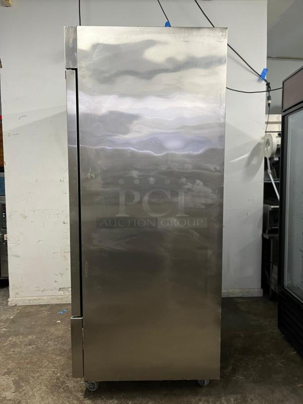 DUKERS D55R 55" reach-in refrigerator, two sections, stainless steel, visible minor wear, industrial setting.