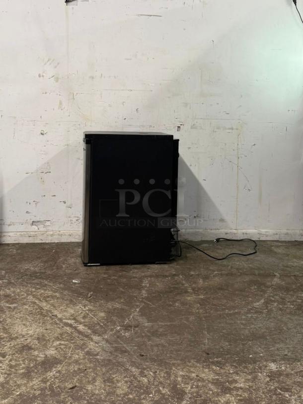 Kegco 20" Wide Stainless Steel Kegerator Cabinet, Model MDK-199SS-01, in used condition, shown on a textured floor.