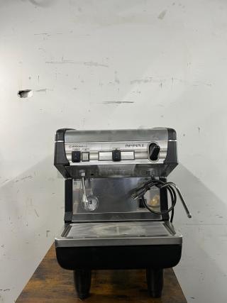 Nuova Simonelli Appia II espresso machine, commercial-grade, stainless steel, reliable, visible power cord, good condition.