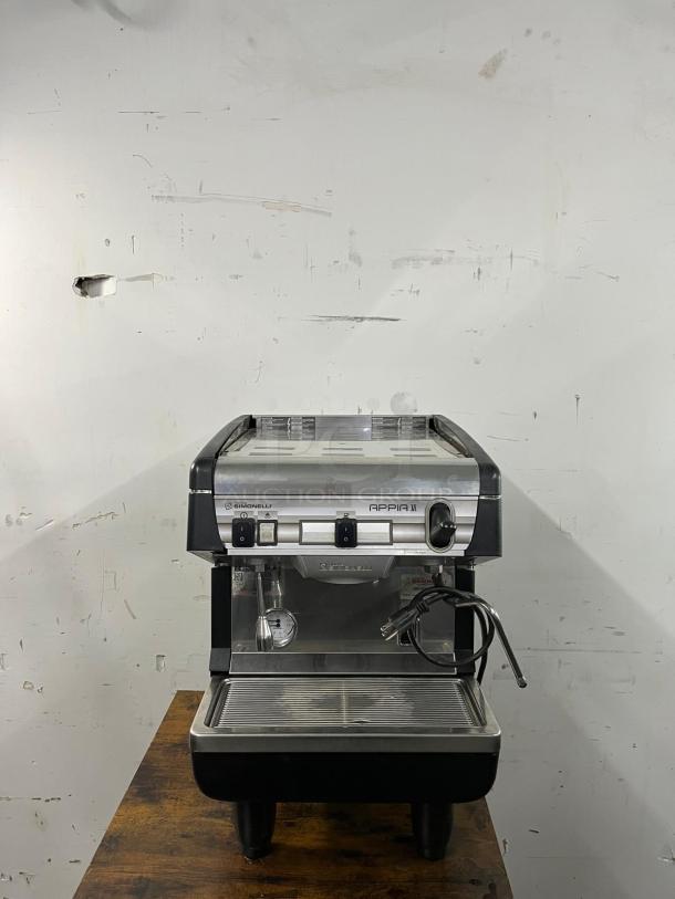 Nuova Simonelli Appia II commercial espresso machine, stainless steel, dual control buttons, steam wand, used condition.