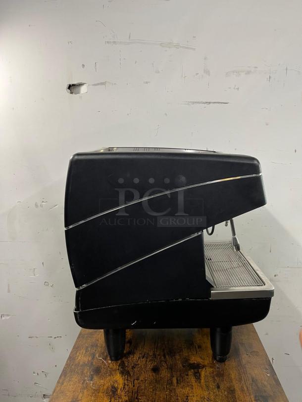 Nuova Simonelli Appia II espresso machine, commercial-grade, black exterior, stainless steel details, good condition.