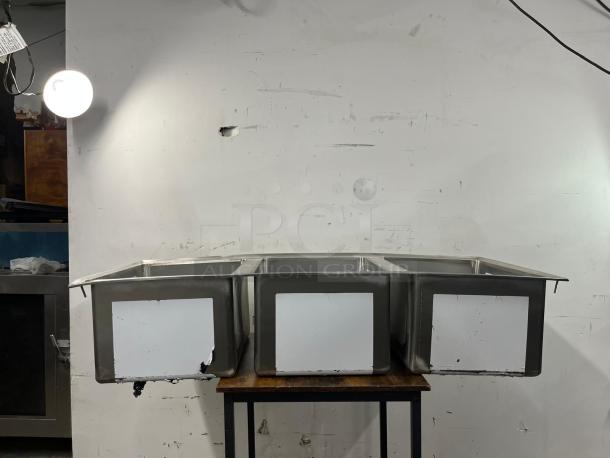 BRAND NEW Regency 16-gauge stainless steel three-compartment drop-in sink, model 600DI31612, on display.