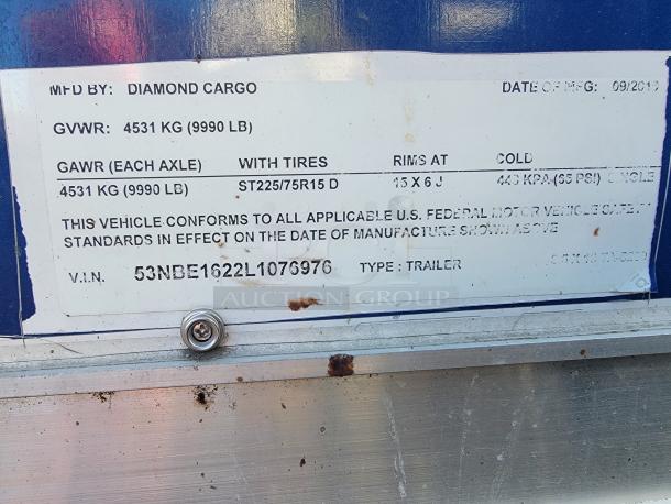 2020 Diamond Cargo trailer label showing GVWR as 9990 LB, compliance with US safety standards, and V.I.N. details.