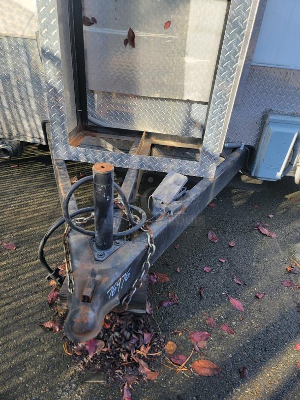 2020 Diamond Cargo 16' food trailer hitch and exterior detail. Features robust steel frame and chain, visible markings "76976".