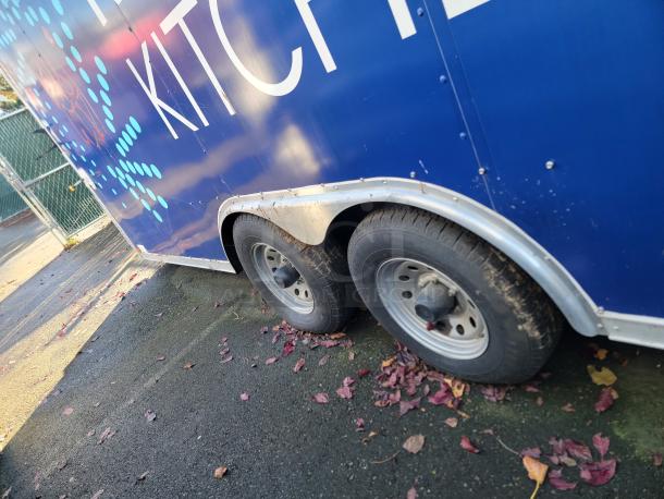2020 Diamond Cargo Food Trailer with dual axle, blue exterior, and white "Kitchen" lettering. Perfect for mobile food business.