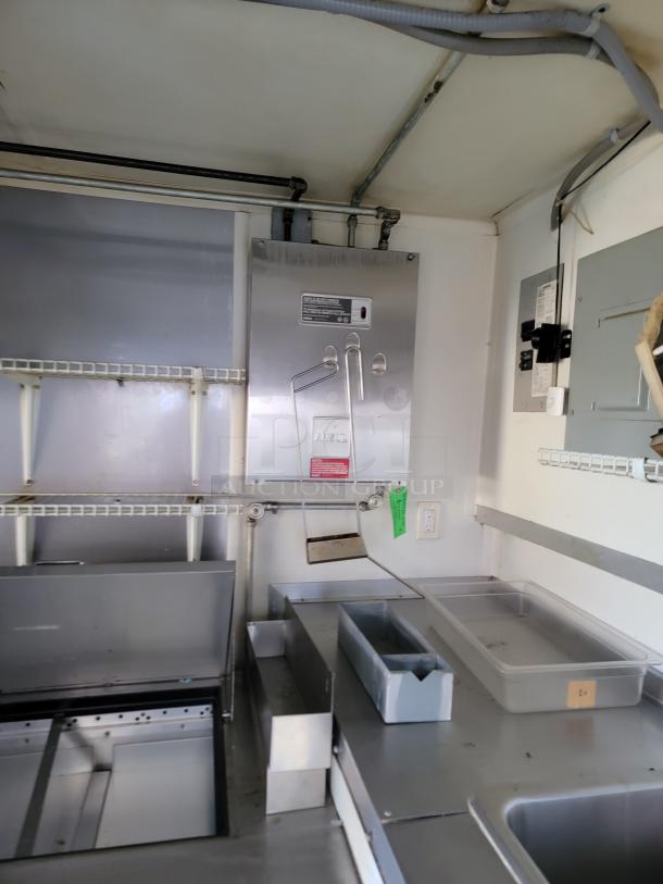Interior of a 2020 16' Diamond Cargo food trailer with stainless steel commercial kitchen equipment and shelving, ready for use.