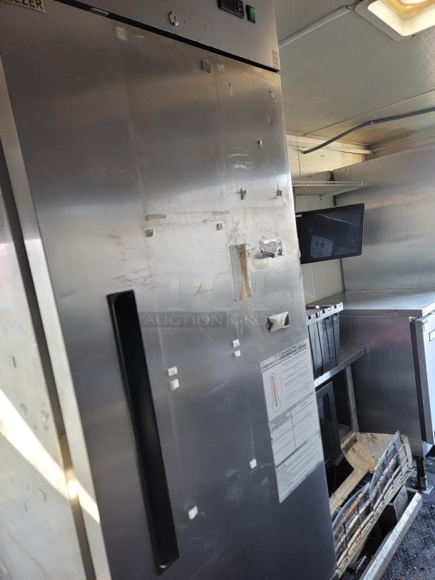 2020 16' Diamond Cargo food trailer interior with commercial-grade True refrigerator, stainless steel finish.