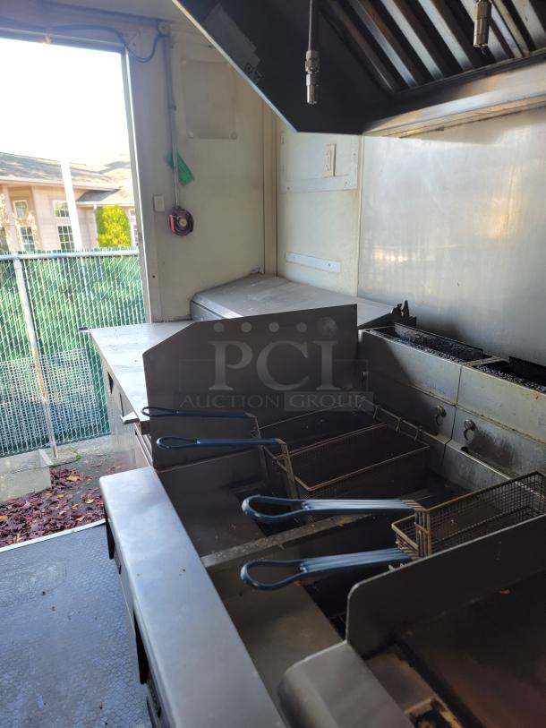 2020 Diamond Cargo food trailer interior with Wells cooking surface, fryers, stainless steel prep area, and ventilation system.