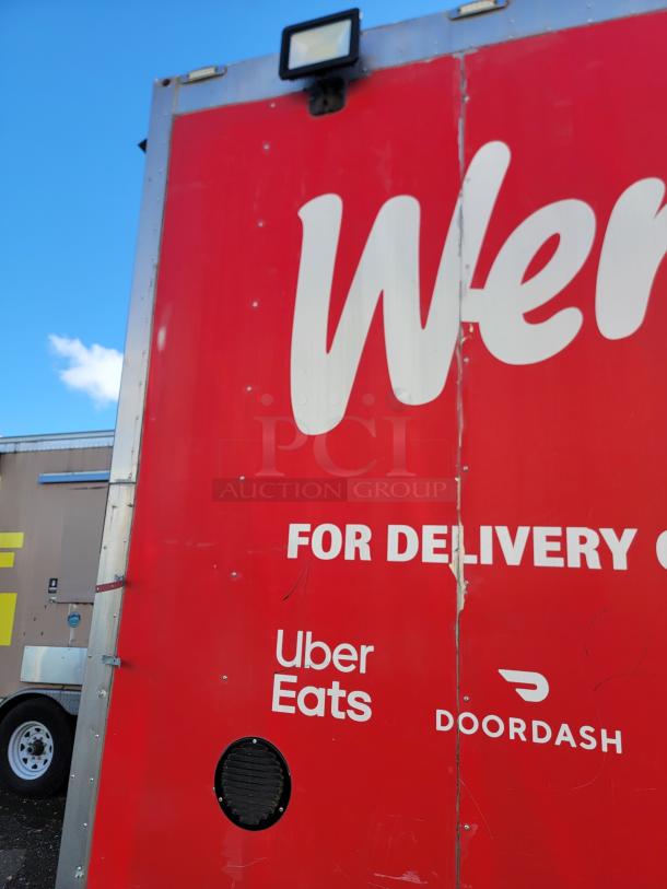 2021 Texino 28' Food Trailer, red exterior, icons for Uber Eats and DoorDash. Ideal for high-volume mobile cooking.