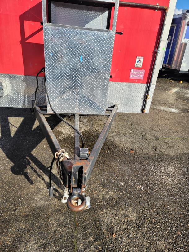 2021 28' Texino Food Trailer hitch, red exterior, diamond plate detail, propane shut off label, well-maintained condition.