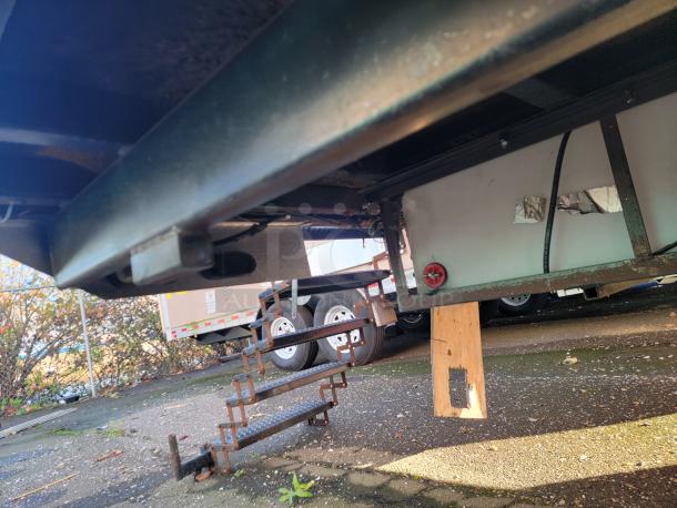 Underside of 2021 28' Texino Food Trailer showing structural support and components. Well-maintained, ideal for mobile kitchen.