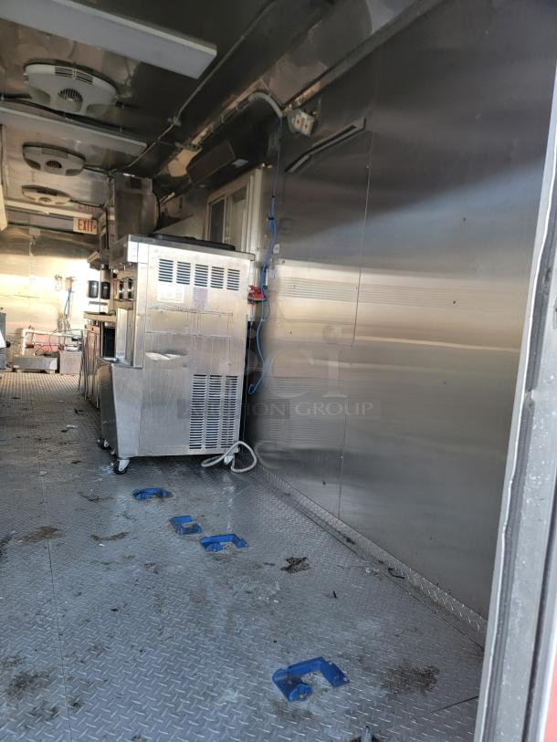2021 Texino 28' Food Trailer interior, featuring commercial refrigeration units and heavy-duty exhaust hood, turnkey condition.