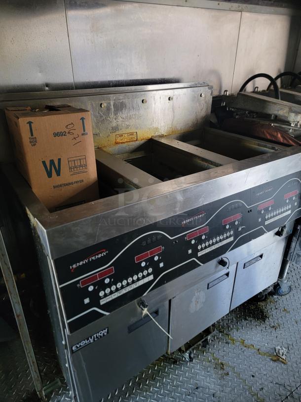2021 Texino Food Trailer interior with Henny Penny Evolution fryer, pristine condition, and durable flooring for commercial cooking.