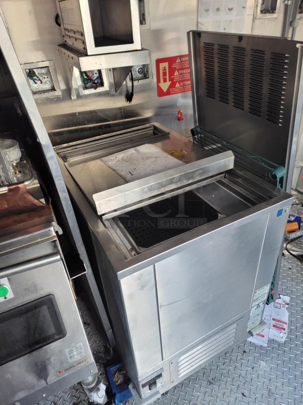 2021 Texino Food Trailer interior showing premium appliances, including a Henny Penny fryer and commercial clamshell grill.
