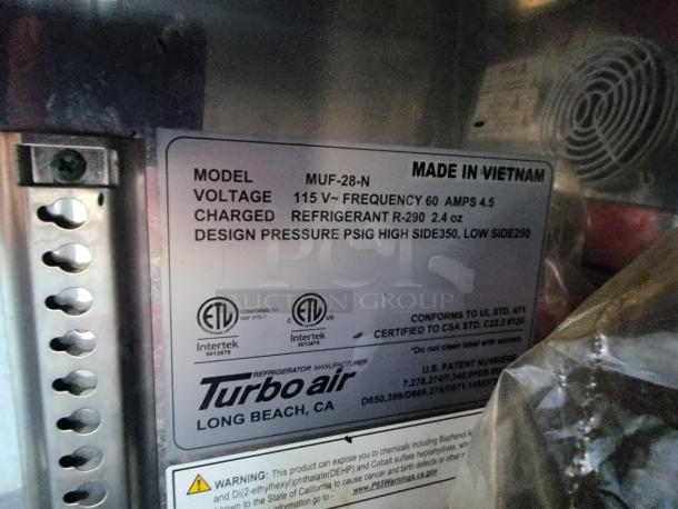 Alt text: 
Label on Turbo Air refrigeration unit showing model MUF-28-N, voltage 115V, refrigerant R-290, and NSF certification.