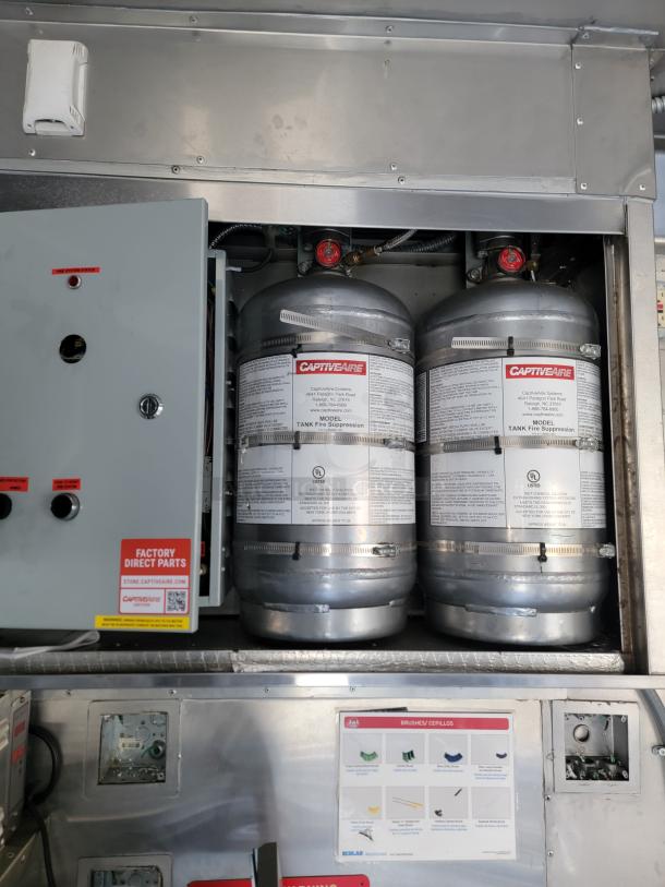 CaptiveAire fire suppression tanks in a 2021 Texino Food Trailer. Factory Direct Parts label visible.