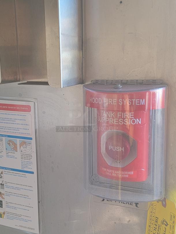 Hood fire suppression system inside 2021 Texino Food Trailer, featuring safety instructions and contact details for service.