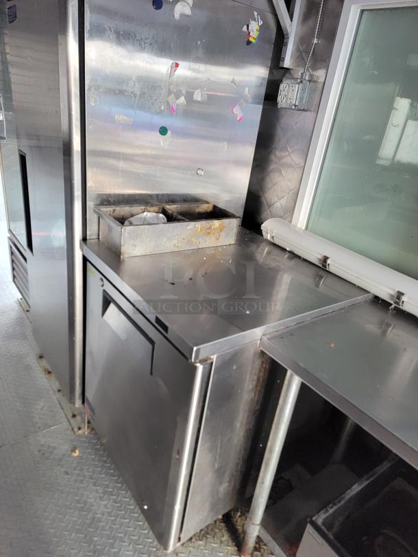 Professional-grade 24' Quality food trailer interior with stainless steel surfaces and Turbo Air refrigeration, ready for service.
