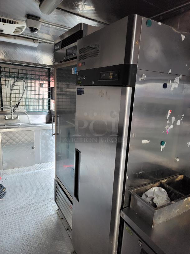 Professional-grade 24' Quality food trailer interior, featuring durable stainless steel and Turbo Air refrigeration.