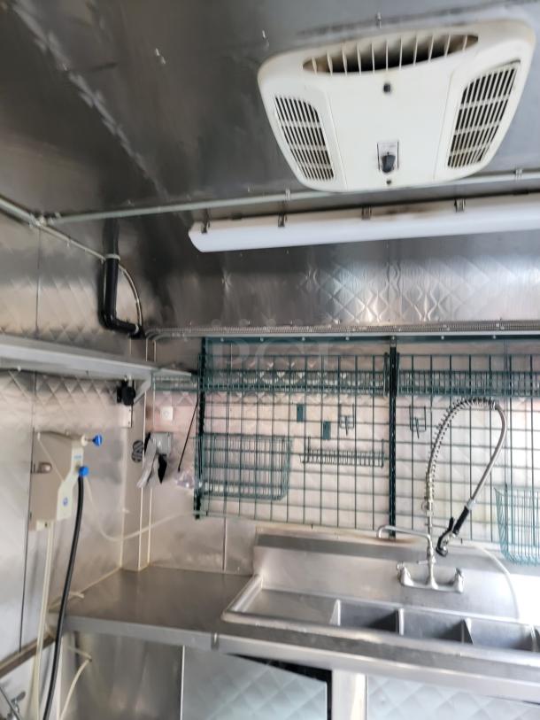 Fully equipped 24' Quality food trailer with stainless steel interior, Turbo Air refrigeration, and NSF-certified equipment.