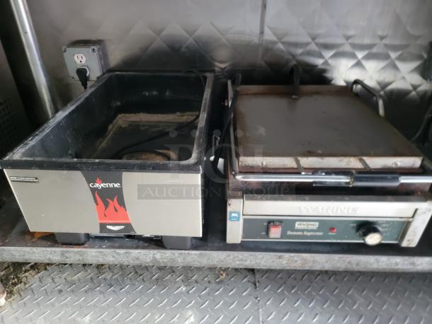 Professional-grade Cayenne food warmer and Waring toaster in a 24' Quality food trailer, stainless steel interior.