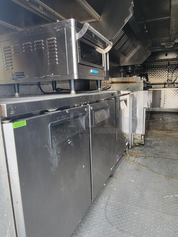 2020 Quality 24' food trailer interior, featuring stainless steel appliances, good condition, ready for business.