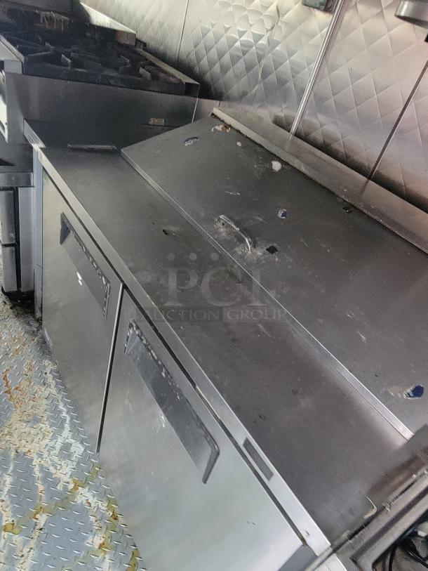 2020 24' Quality food trailer interior, showing stainless steel appliances, dual prep counters, and gas range in used condition.