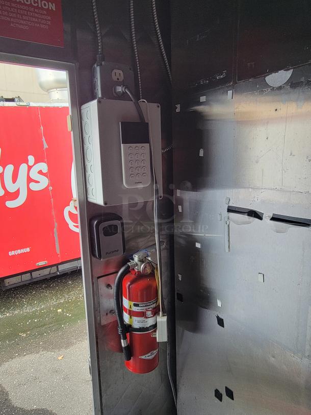 2020 Quality 24' food trailer interior showing electrical panel, outlet, and fire extinguisher. Ready for immediate use.