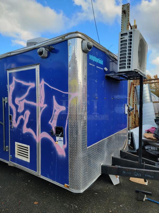 Blue 2019 Quality 24' food trailer with pink graffiti, featuring diamond plate trim and external air conditioning unit.