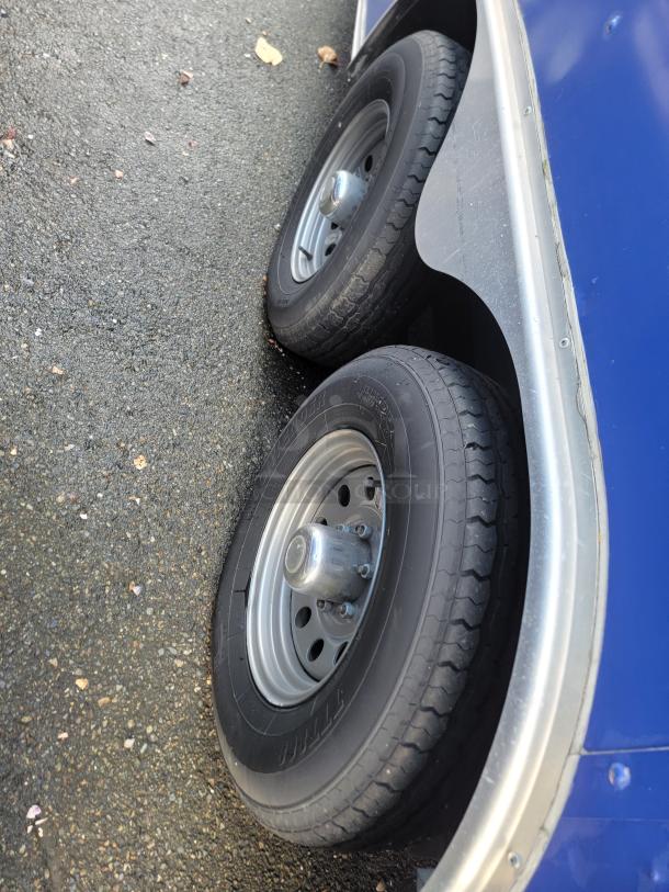 2019 Quality 24' food trailer wheels shown. Features dual tires on durable metal rims, clean and ready for customization.