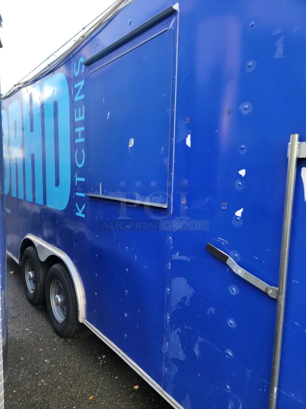 Blue 2019 Quality 24' food trailer. Features include twin axles, serving window. Some surface wear visible, ideal for customization.