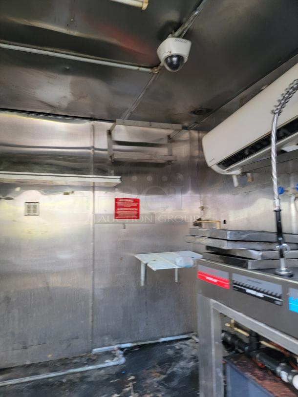 2019 Quality 24' empty food trailer interior, stainless steel walls, ceiling camera, air conditioning unit, clean condition.