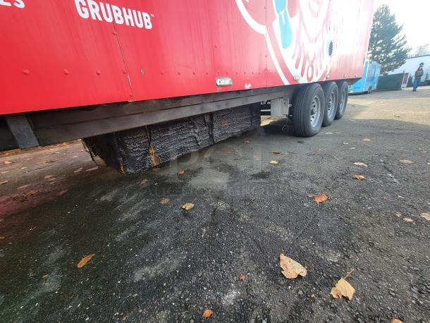 2021 Texino 28' food trailer exterior view showing sturdy tires and a Grubhub advertisement.