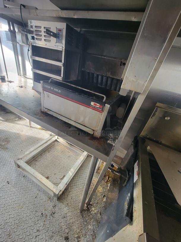 2021 Texino 28-foot food trailer interior with Antunes Crisp N' Hold station, stainless steel setup, and commercial kitchen equipment.