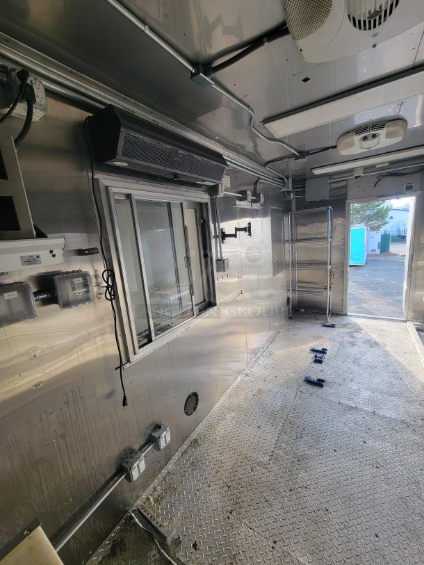 2021 Texino 28-foot food trailer interior, showing stainless steel walls, commercial-grade appliances, and professional exhaust hood.