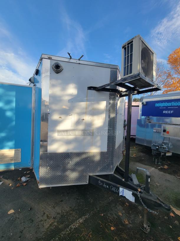 2019 Quality 24' food trailer exterior with mounted HVAC unit, diamond-plated trim, and hitch. Clean, ready for use.