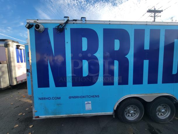 2019 Quality 24' food trailer, blue with "NBRHD" logo, featuring cameras and dual wheels. Info: NBRHD.COM, @NBRHDkitchens.
