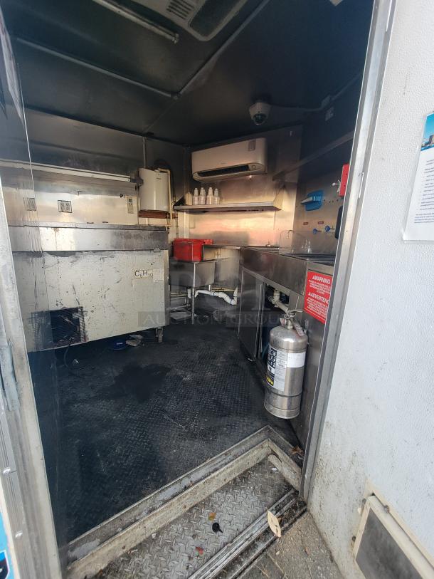 2019 Quality 24' food trailer interior; visible features include fryers, griddle, refrigeration units, and fire extinguisher.