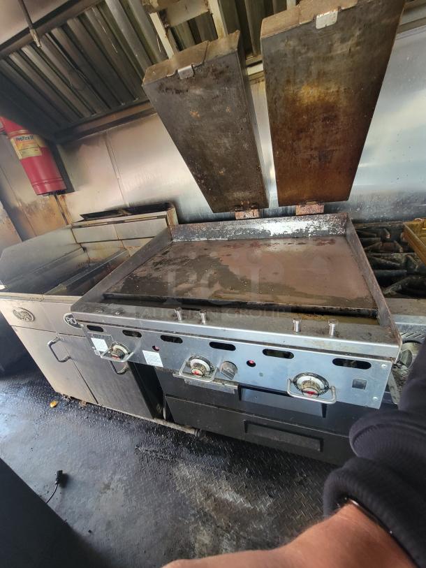 2019 Quality 24' food trailer interior with Royal Range RMG-36 griddle. Features natural gas fryers and commercial appliances. Ready to operate.