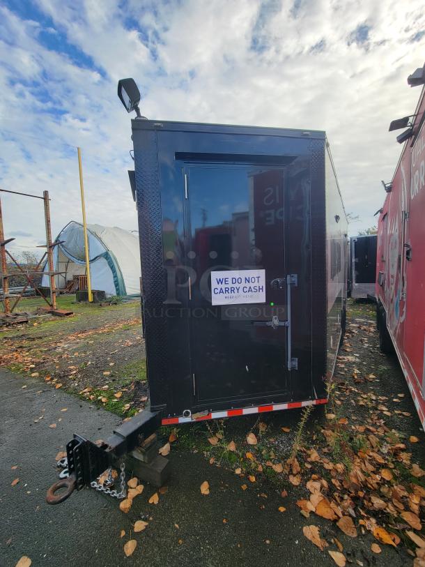 2021 SDG 20' mobile ghost kitchen trailer, dual-axle, black exterior, "We Do Not Carry Cash" sign, designed for high-volume delivery.