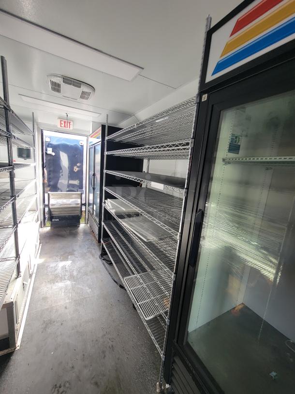 2021 SDG 20' Mobile Ghost Kitchen/Convenience Trailer with commercial shelves and refrigeration units, excellent condition.