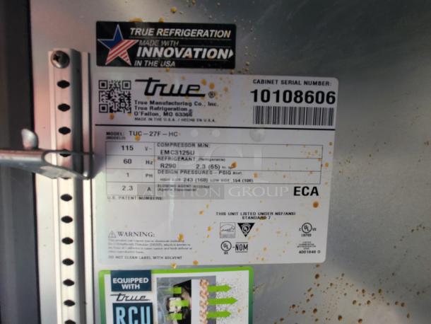 Sticker on refrigeration equipment showing model TUC-27F-HC. Includes specifications like serial number 10108606, refrigerant R290, and design pressures.