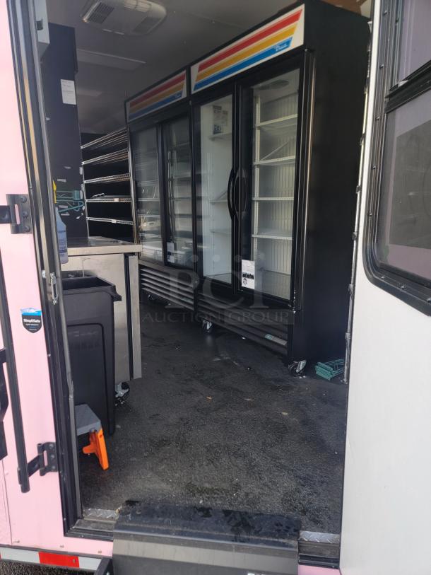 2021 SDG Ghost 20' Food Trailer interior, featuring high-efficiency True commercial refrigerators, stainless steel workspace, and robust plumbing.