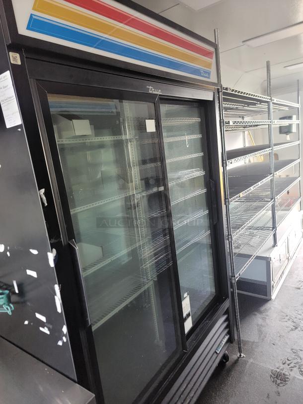 2021 SDG Ghost food trailer, 20-foot model. Features True commercial refrigeration units, stainless steel interior, shelving.