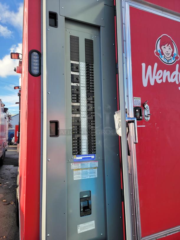 2021 28' Rock Solid Cargo mobile kitchen trailer, red exterior with Wendy's logo, featuring electrical panel.