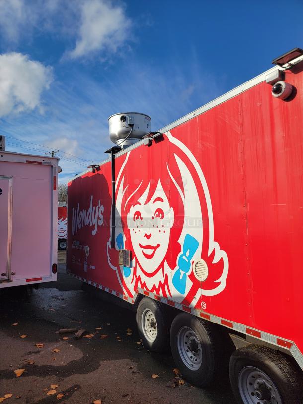 28' Rock Solid Cargo mobile kitchen trailer with Wendy's branding, equipped with high-end commercial appliances for high-volume food service.