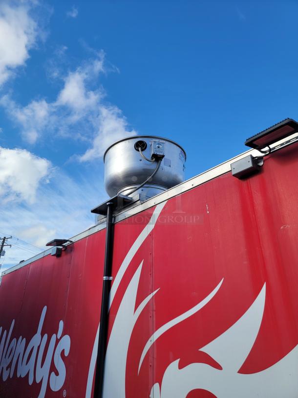 Red 2021 Rock Solid Cargo 28' mobile kitchen trailer with a ventilation unit on top; former Wendy's branding visible.