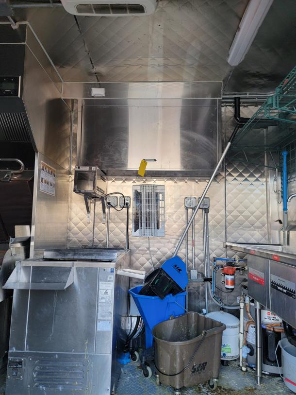 2021 28' Rock Solid Cargo mobile kitchen trailer interior, equipped with commercial appliances and stainless steel surfaces.