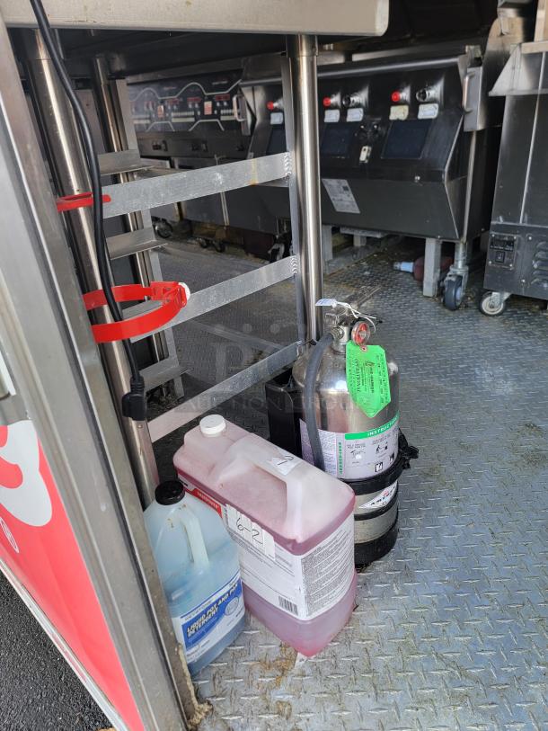 28' Rock Solid Cargo Mobile Kitchen Trailer, featuring Henny Penny fryers, commercial refrigeration, and CaptiveAire hood.